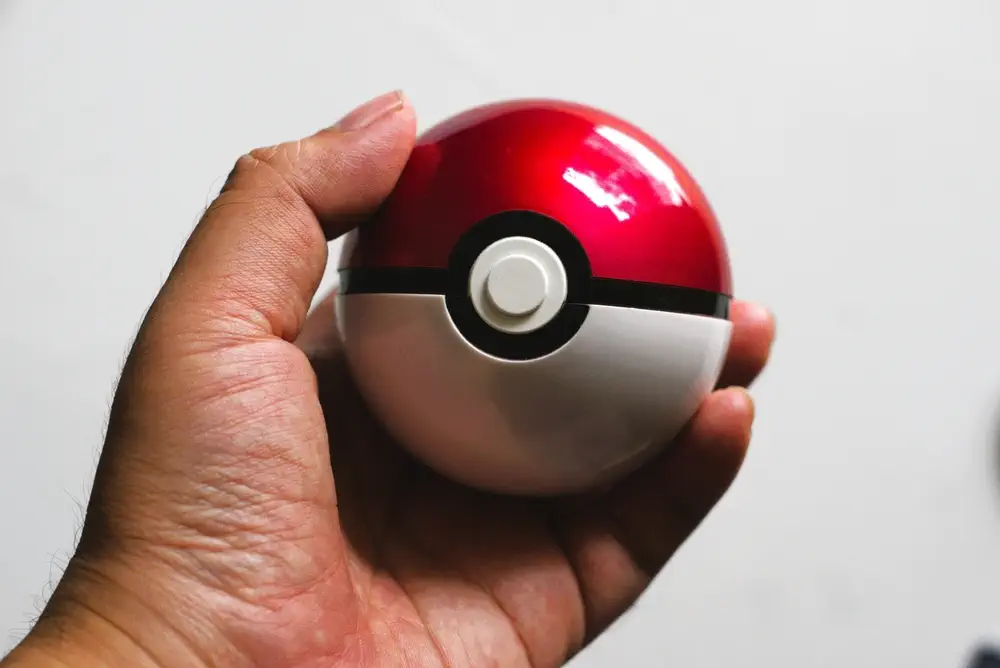 Hand holding a Pokéball